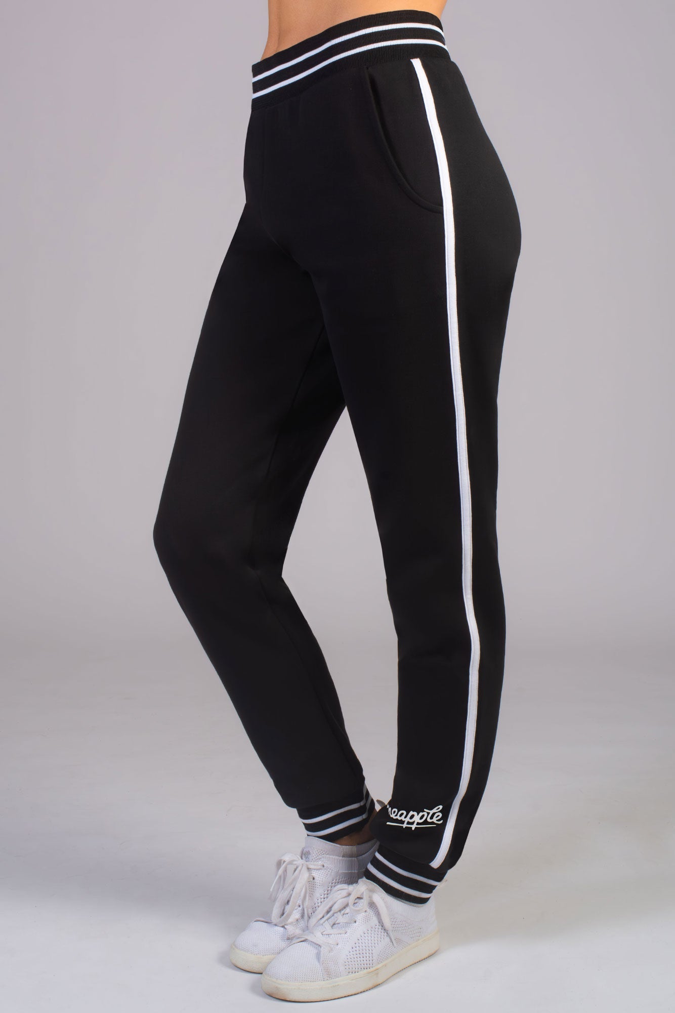 Unisex black joggers with white stripe cuffs and Pineapple Dance Studios logo on the ankle