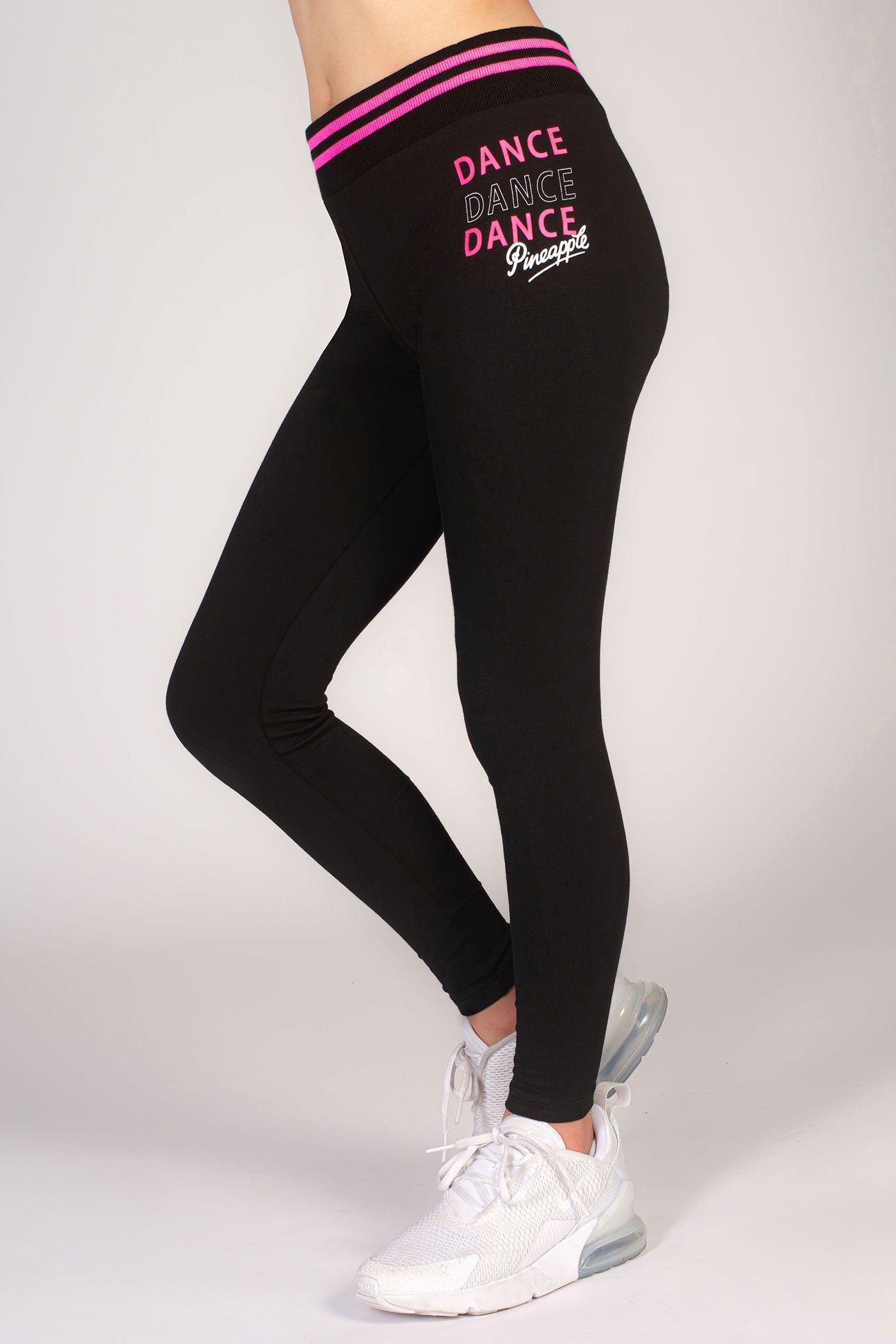 Girls' black dance leggings with pink stripe rib band and dance print on hip.