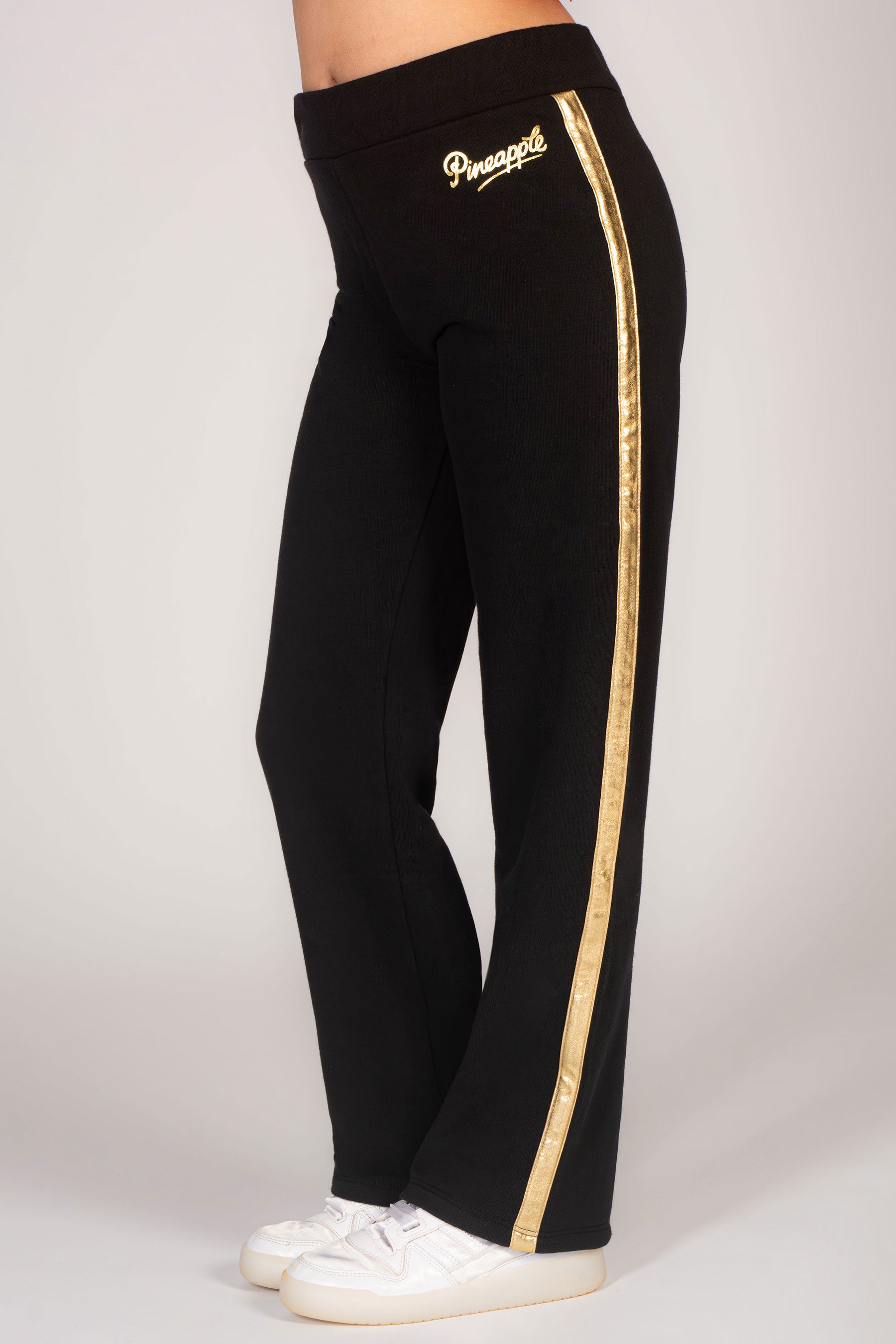 Girls' black wide leg trousers with gol foil detail along the legs, the perfect Christmas loungewear for kids!