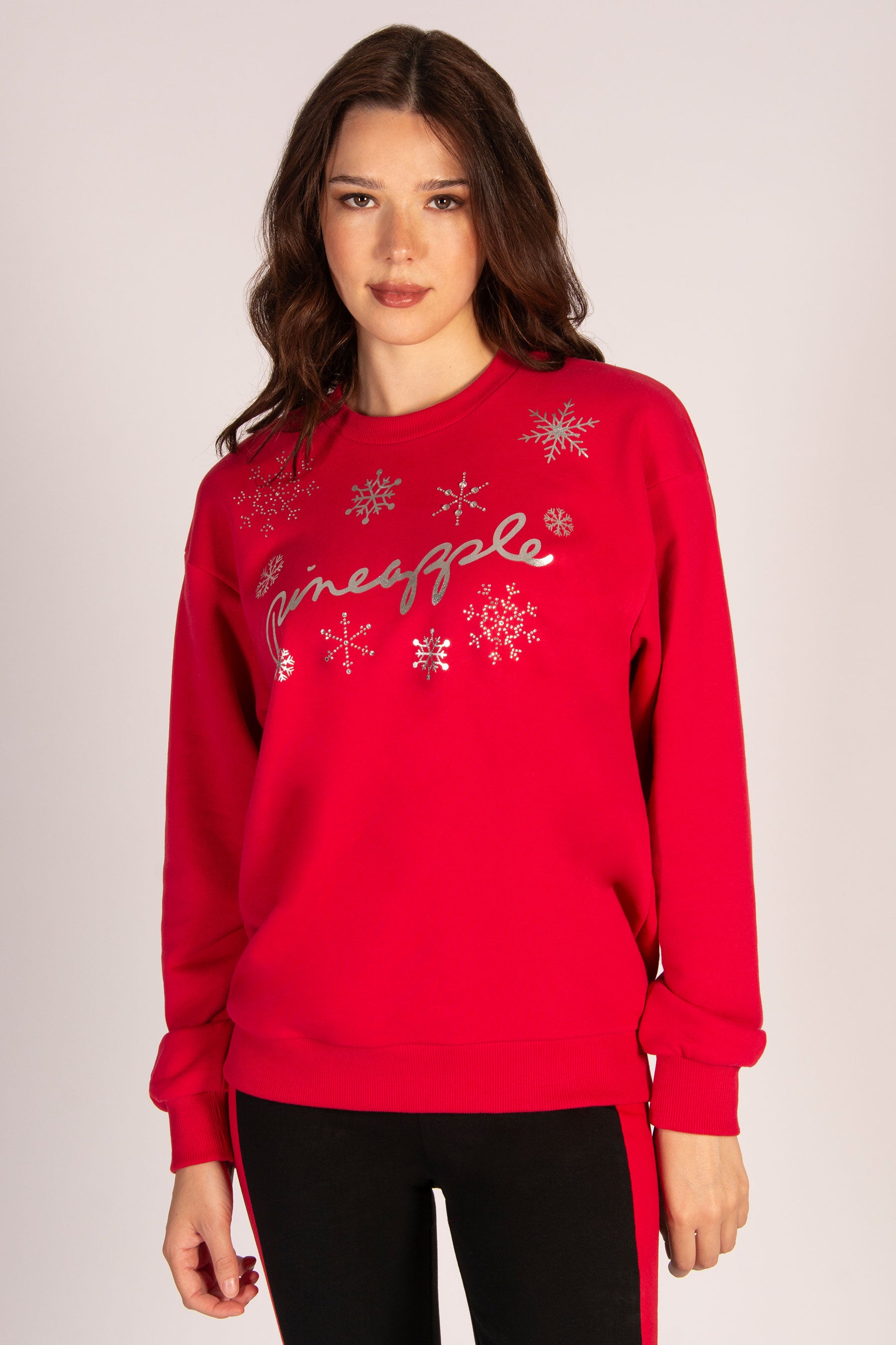 Women's red Christmas sweater with diamanté snowflakes and silver foil design modelled by Martyna Balsam.