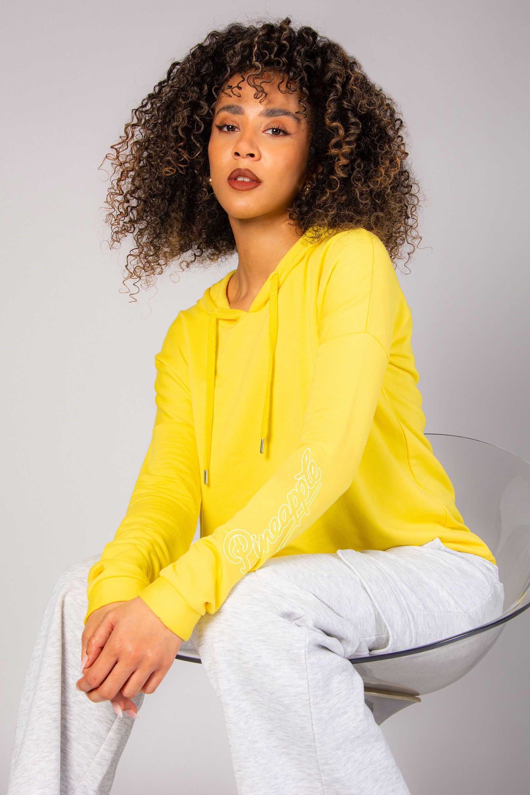Alyce Justyne modelling for Pineapple Dance Studios wearing a yellow dip hem hoodie
