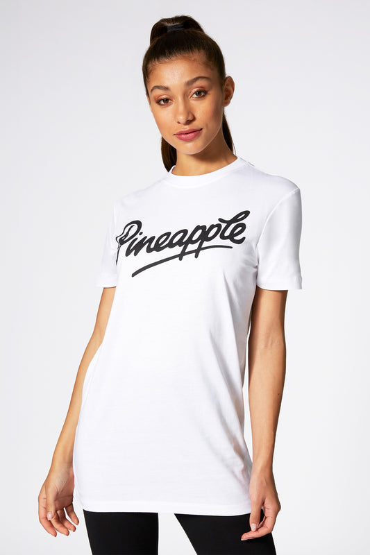 Kaory Desole wearing white t-shirt with Pineapple logo across chest