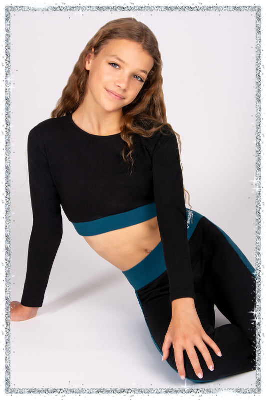 girls wearing a black long sleeve fitted crop top with matching trousers on a grey background.