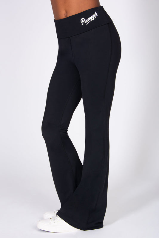 Black flared trousers with a brand logo on a white background