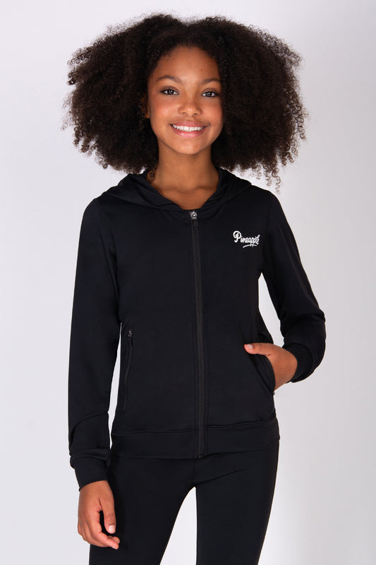 Young girl wearing a black hoodie with a zip and pockets on a white background