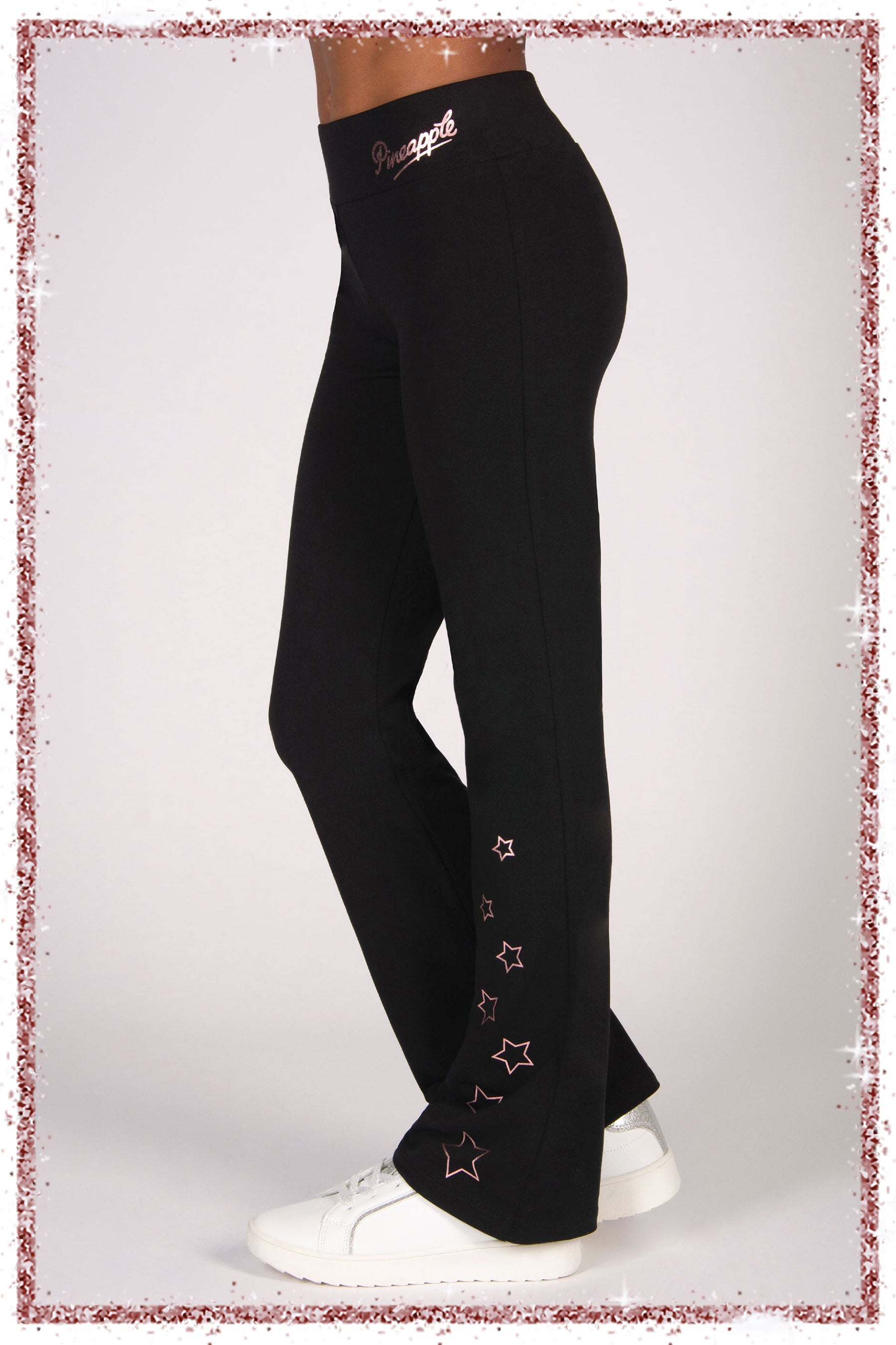 Black pants with star designs and a brand logo on a white background