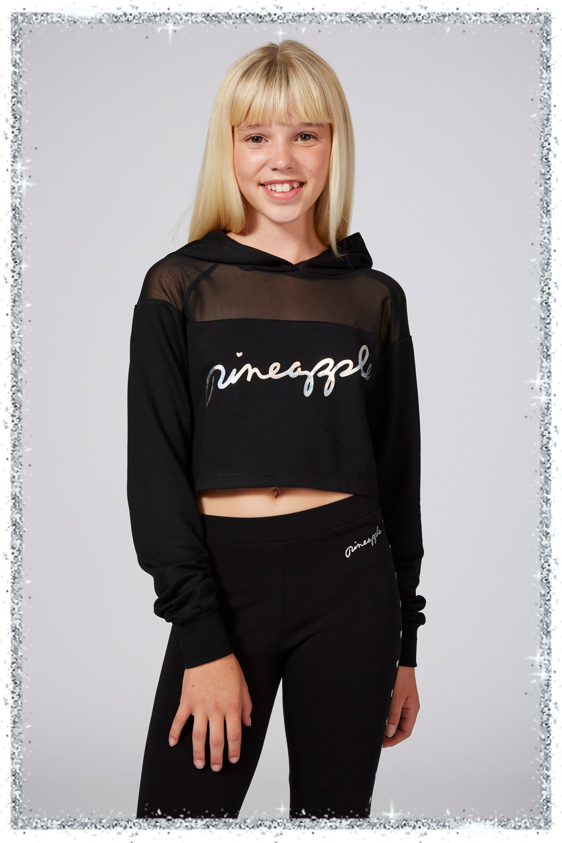 Person wearing a black hoodie with 'pineapple' text on a light gray background