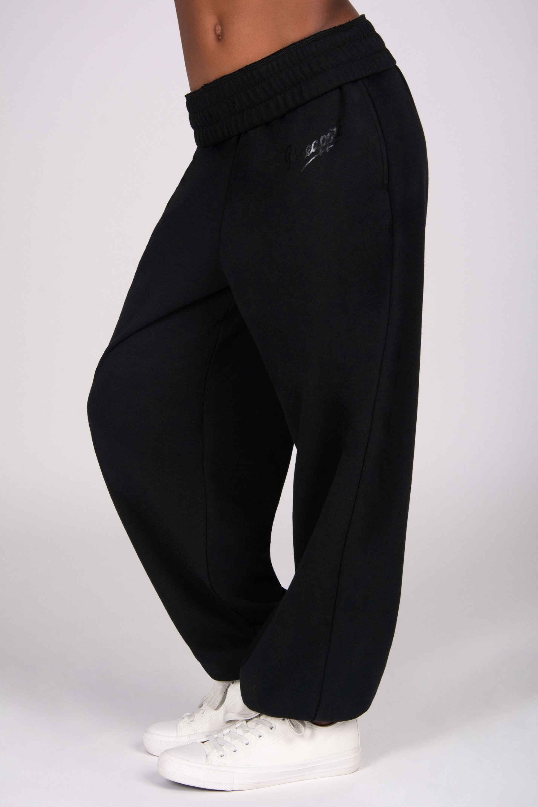 Black oversized wide-leg joggers worn by a person on a white background