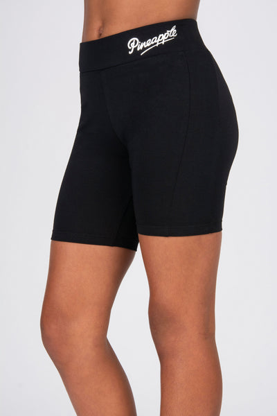 Black shorts with a brand logo on a white background