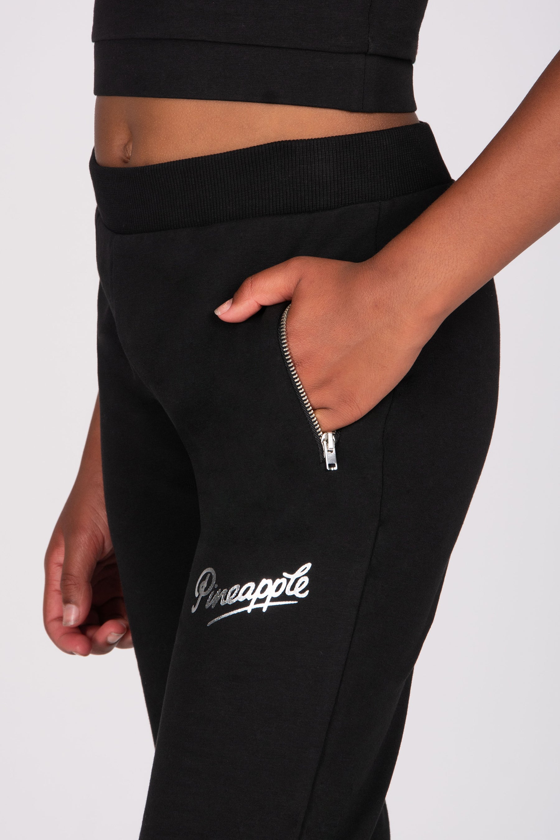 Black jogger pants with a brand logo on a white background