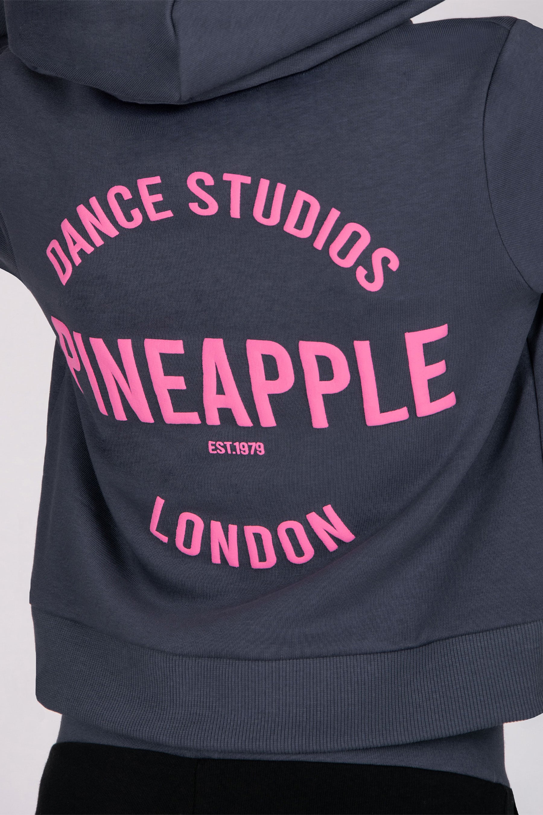 Girls' grey hoodie with pink text 'Dance Studios Pineapple London' on a white background