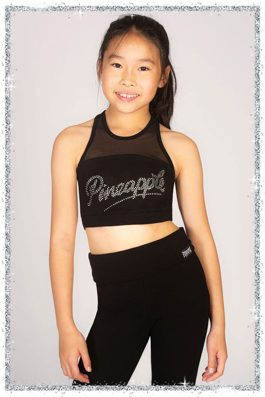 Young girl wearing a black 'Pineapple' sports bra and leggings on a light gray background
