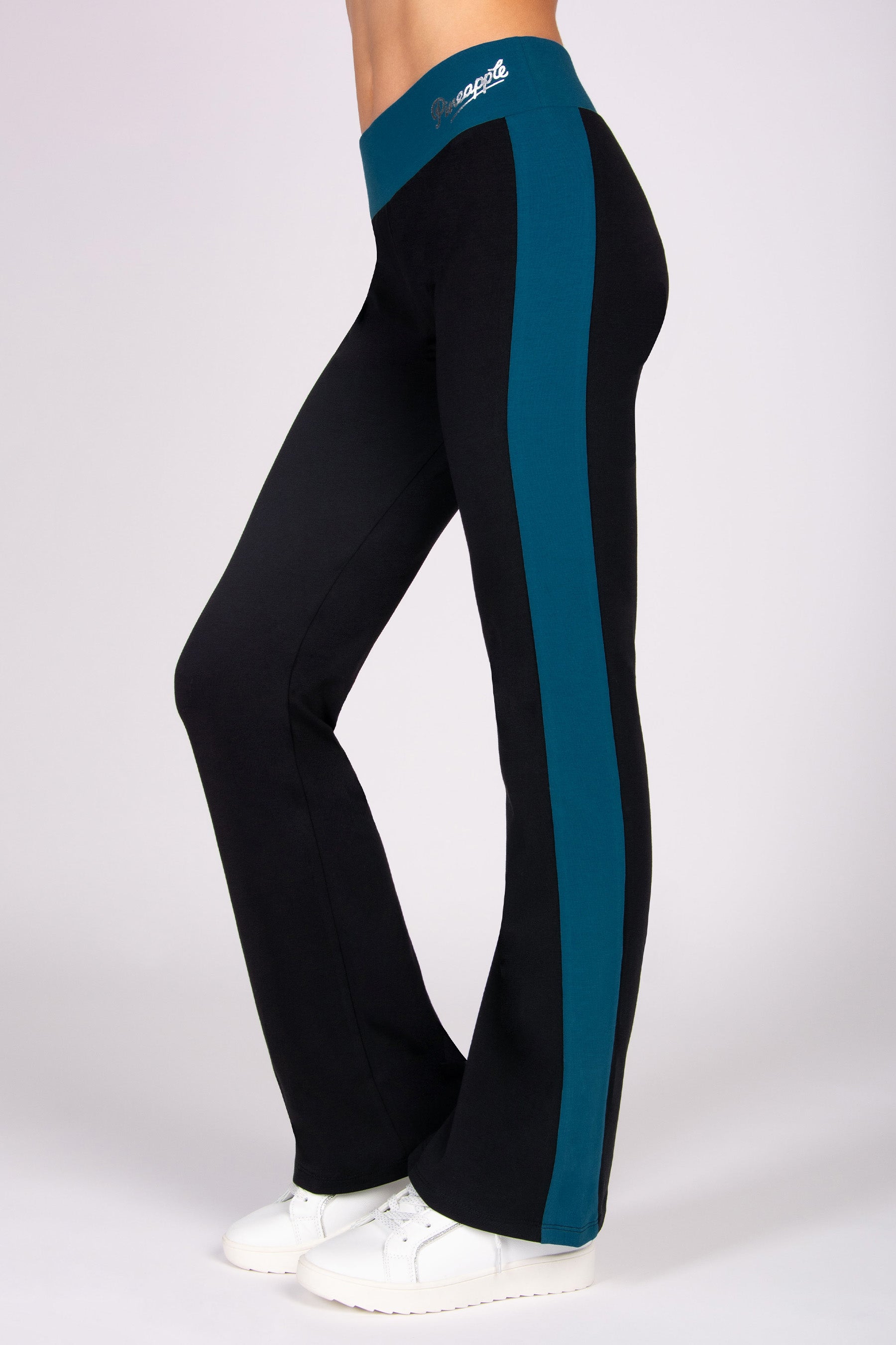 Black flared leggings with a blue stripe on a white background