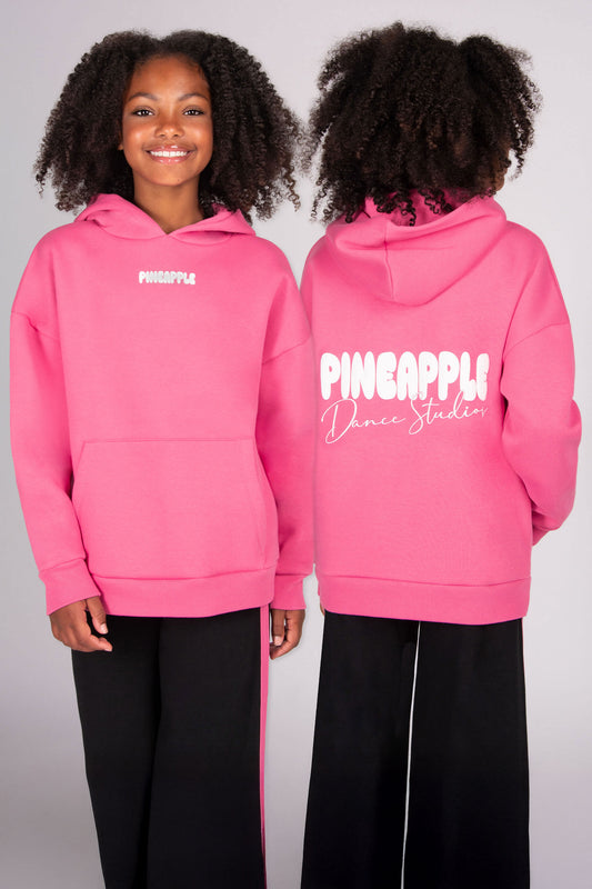 Pink hoodie with 'Pineapple Dance Studios' back print worn by a girl, showing front and back views.