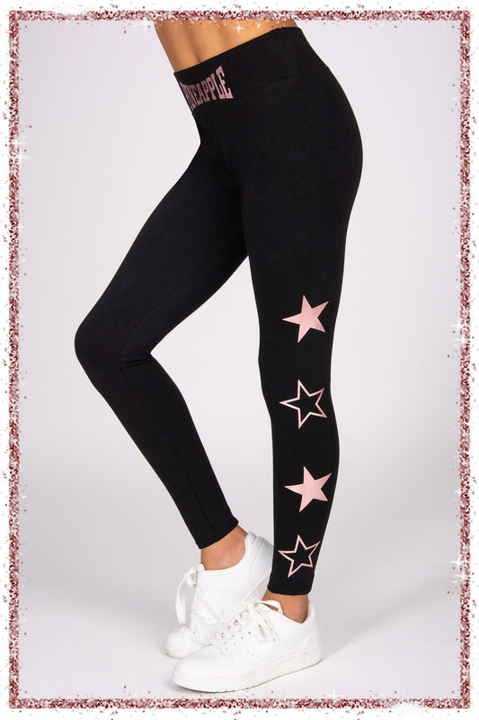 Black leggings with pink star designs worn by a person on a white background