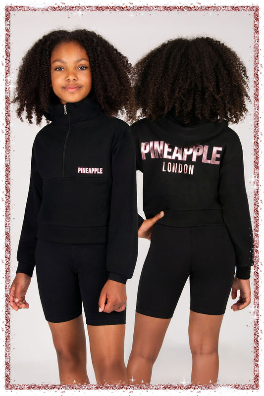 Black Pineapple London hoodie worn by a child, shown from front and back.