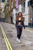 Kianna Louise walking down Langley Street in Covent Garden in the iconic Pineapple's fashion