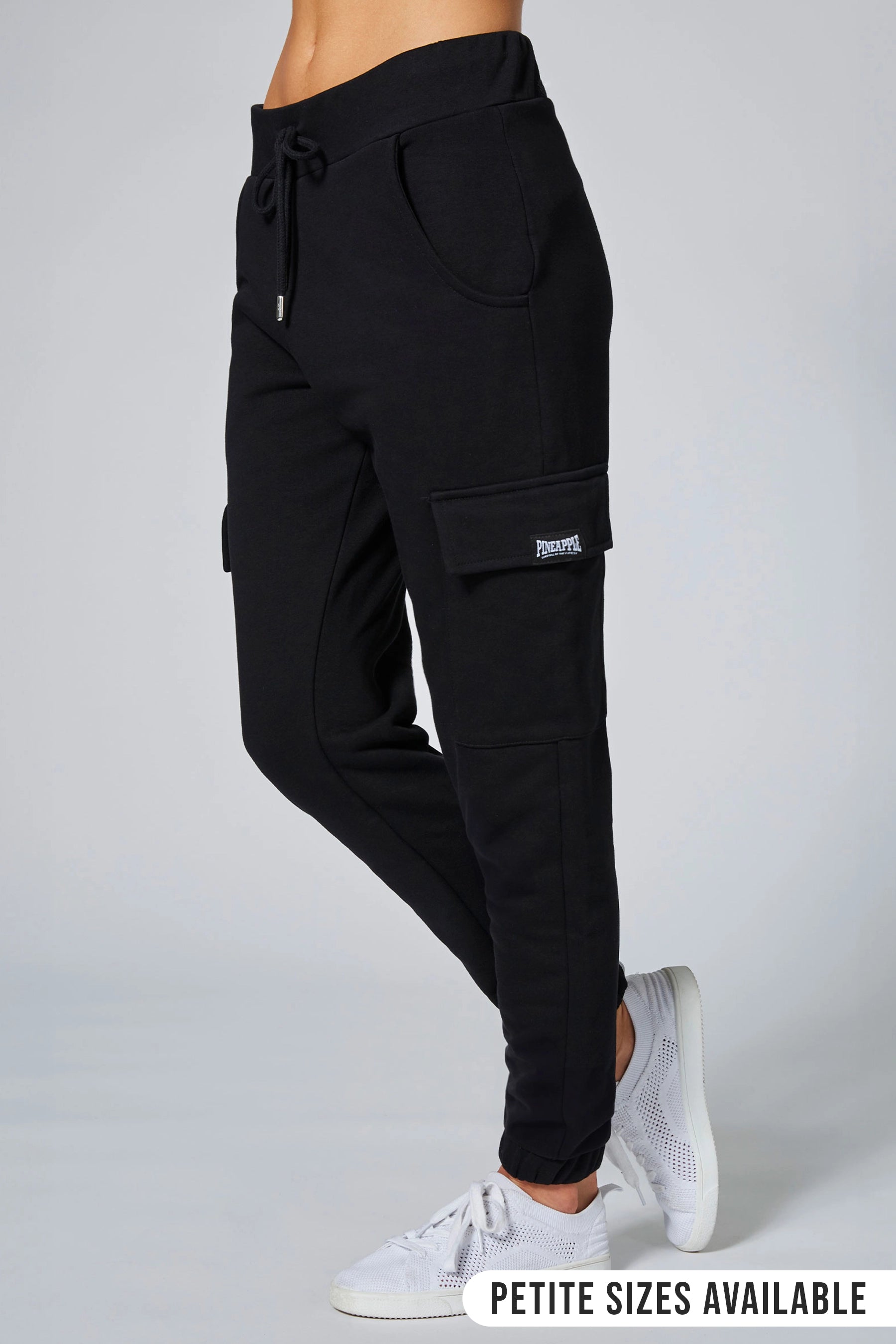 black joggers with cargo pockets and drawcord waistband against a grey background