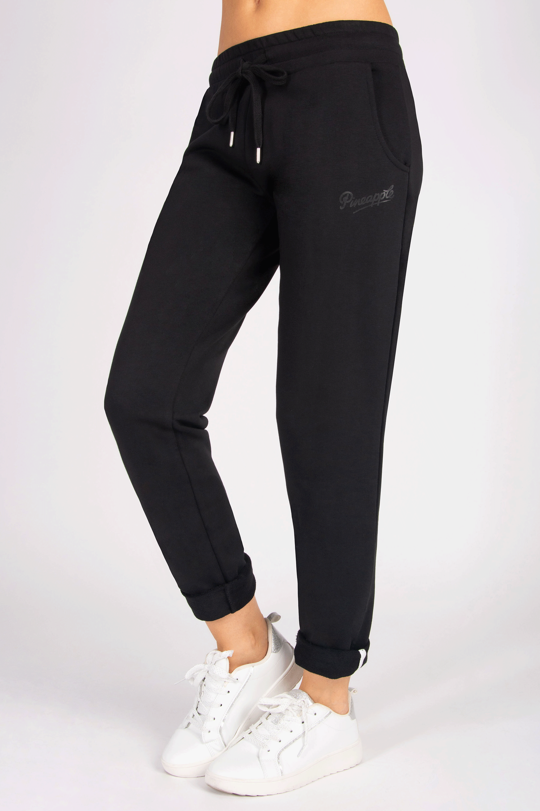 Black joggers with side pockets and waistband with drawcords on a person