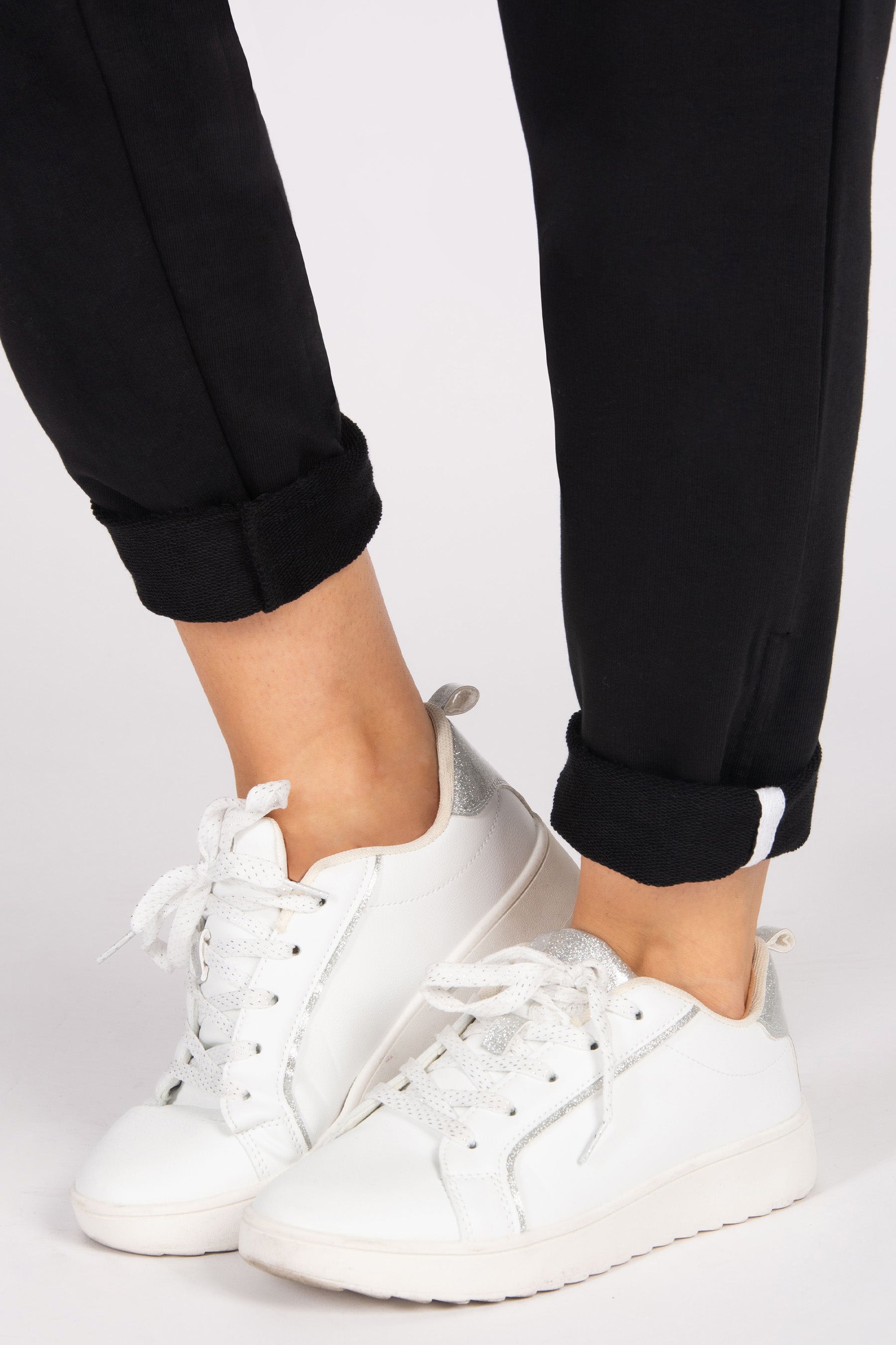 Close up of roll hem joggers on a white background