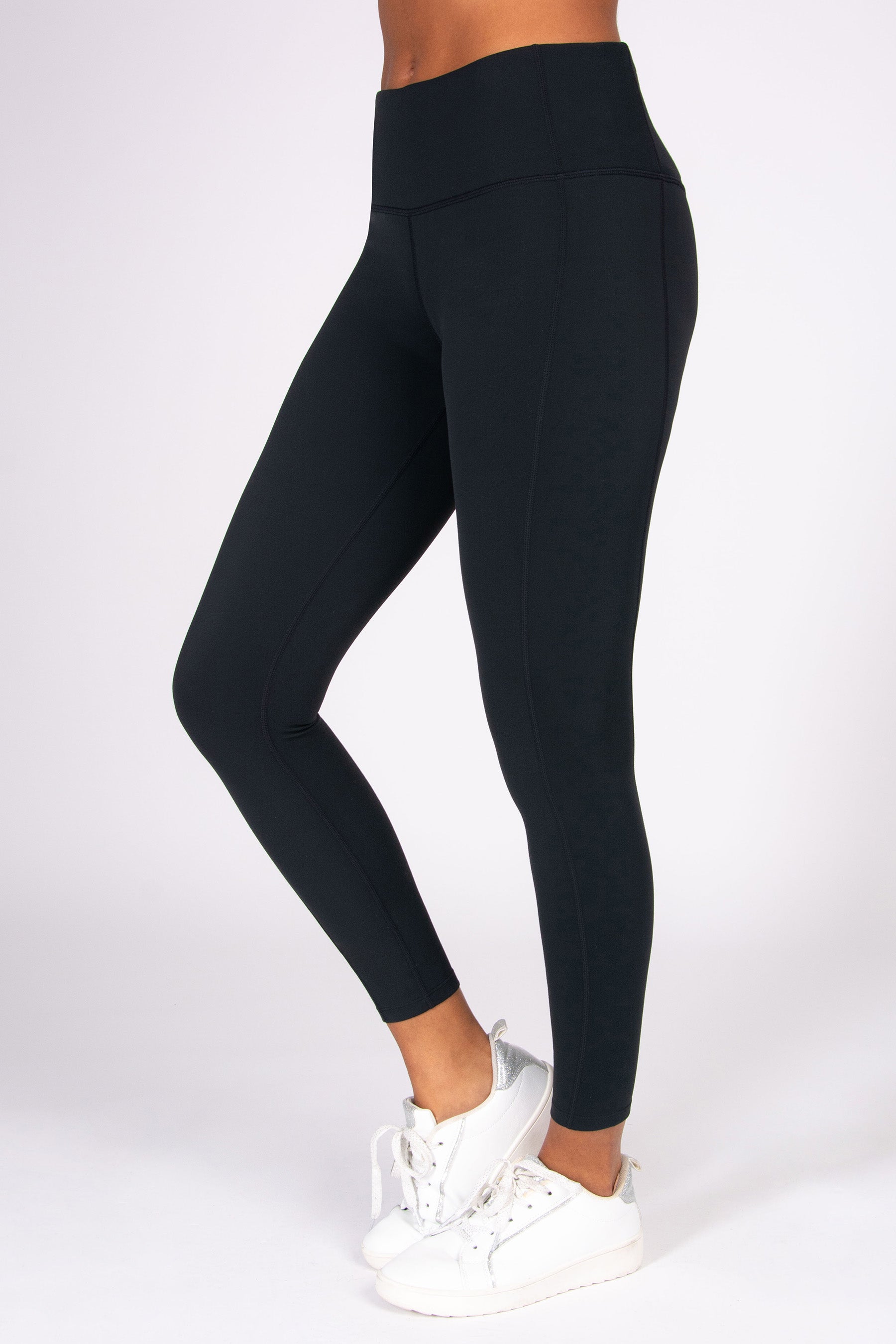 Black super soft 7-8 yoga leggings worn by a person on a white background