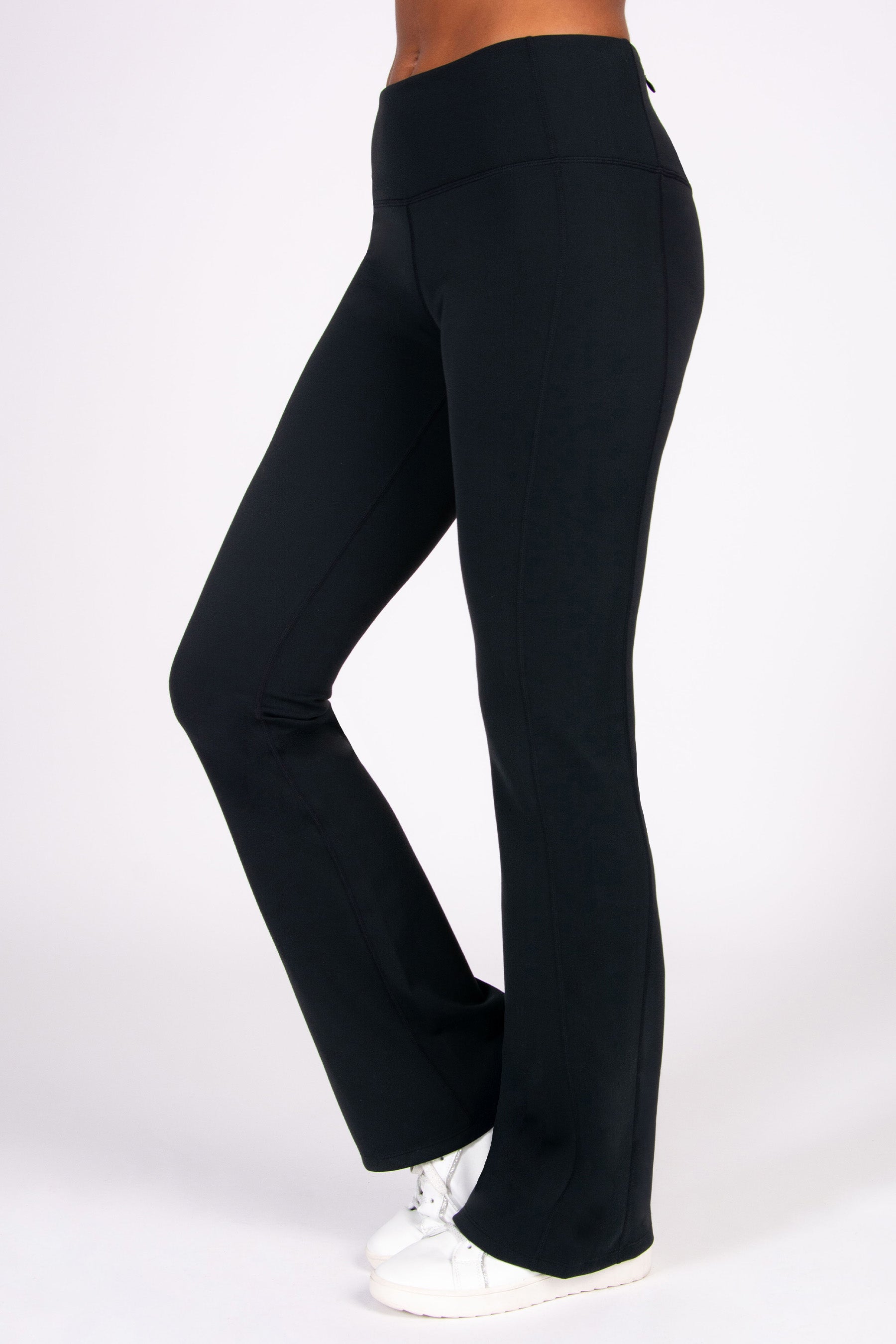 Black super soft flared yoga pants worn by a person on a white background