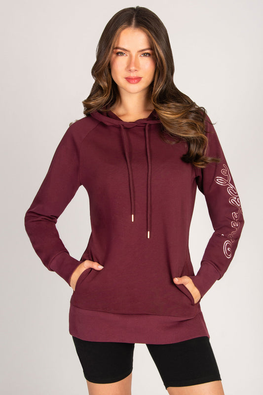 Kianna Louise wearing a burgundy hoodie with a white background