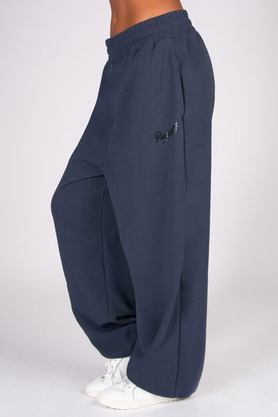 Navy blue boyfriend joggers on a white background