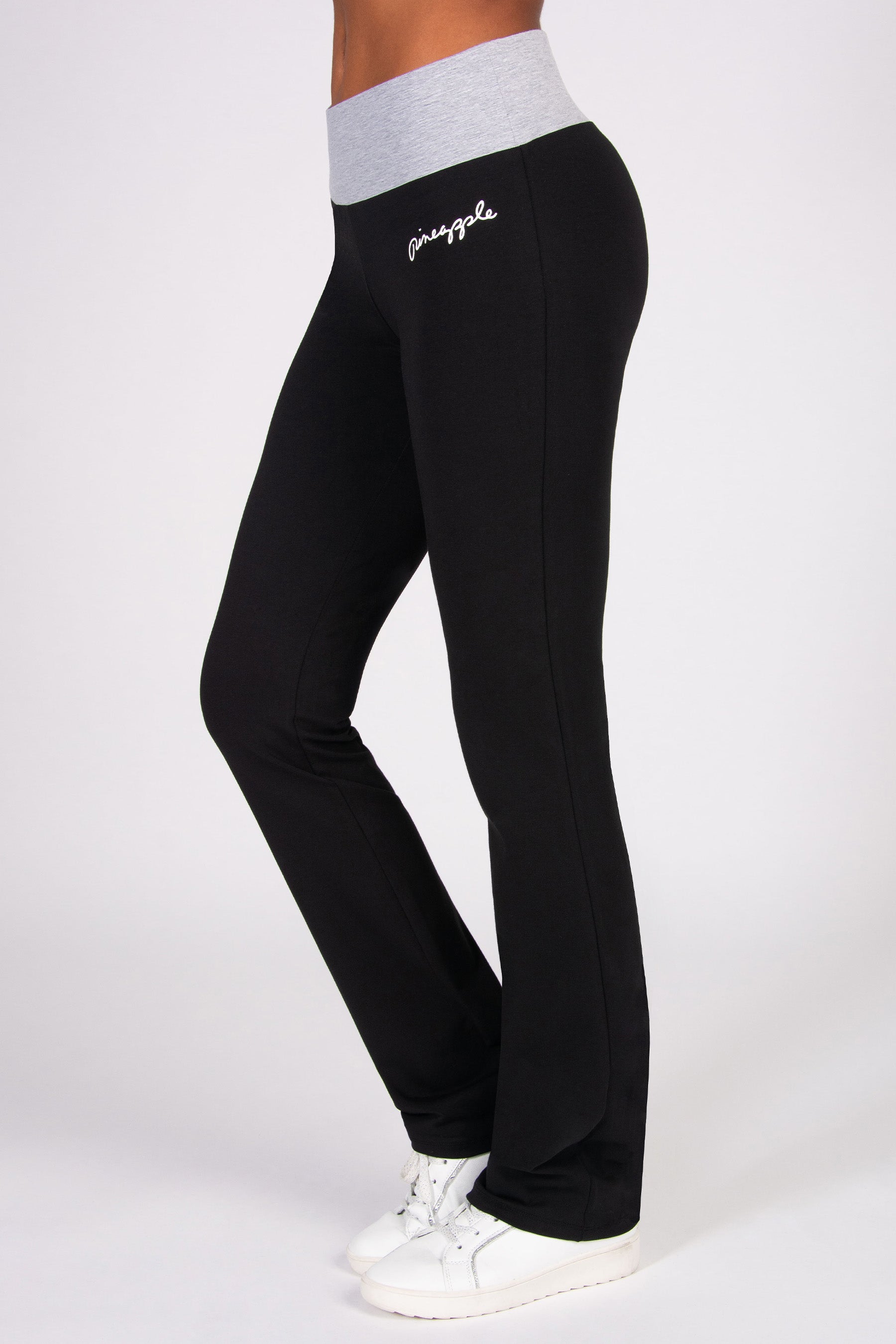 Black flared trousers with a contrast grey marl waistband on a white background