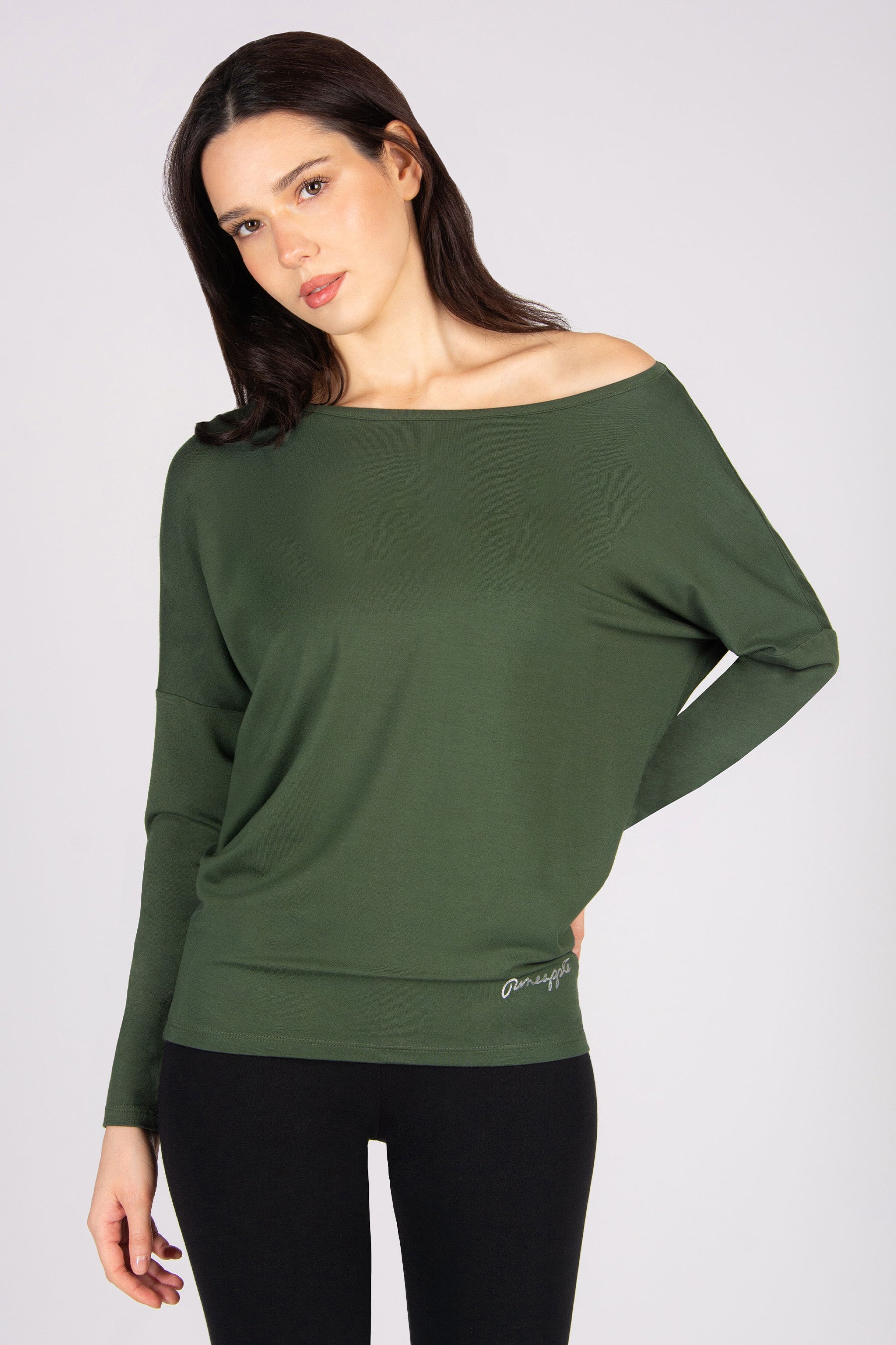 Woman wearing a khaki off-shoulder long sleeve top on a white background