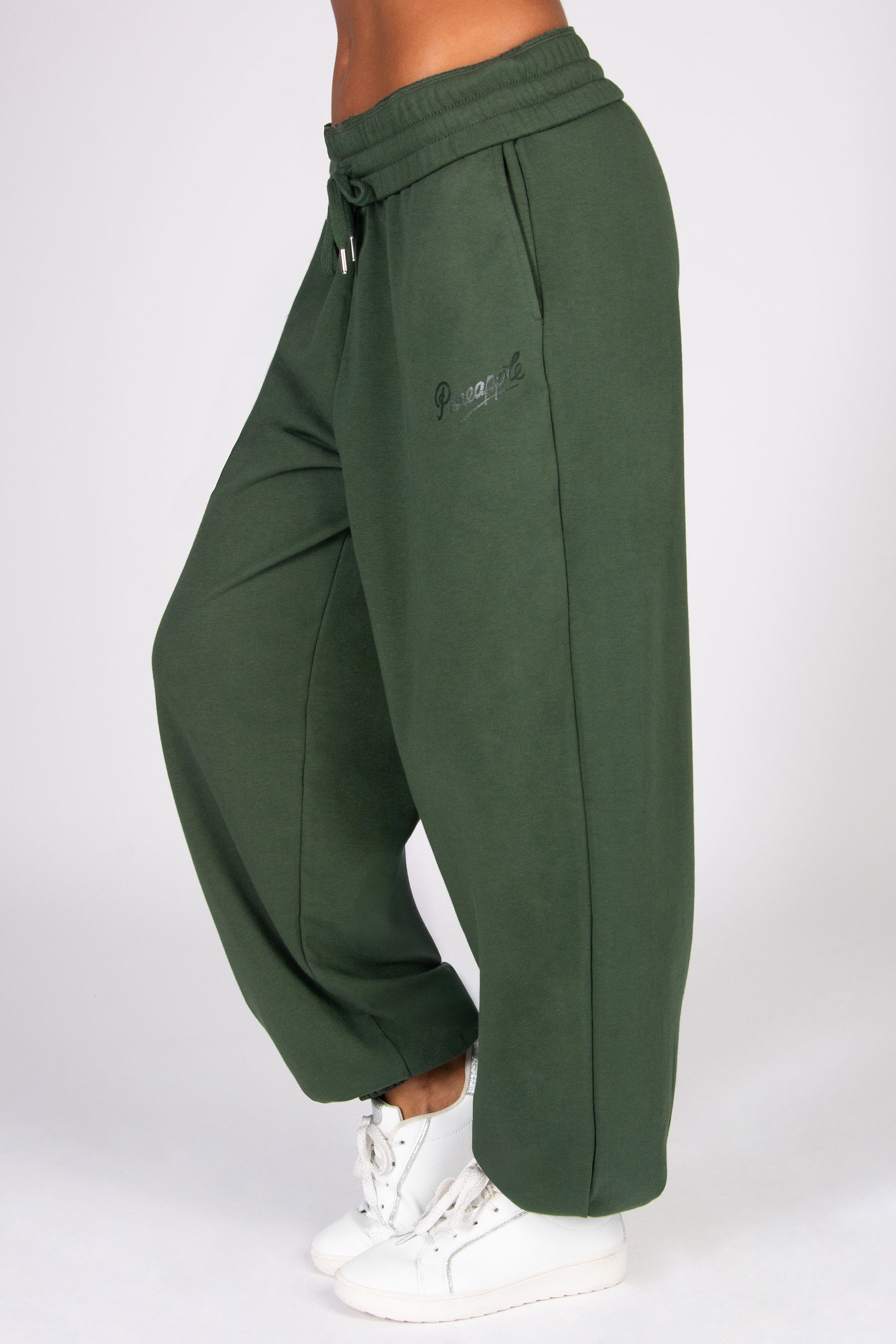 Khaki oversized sweatpants with a logo on a white background