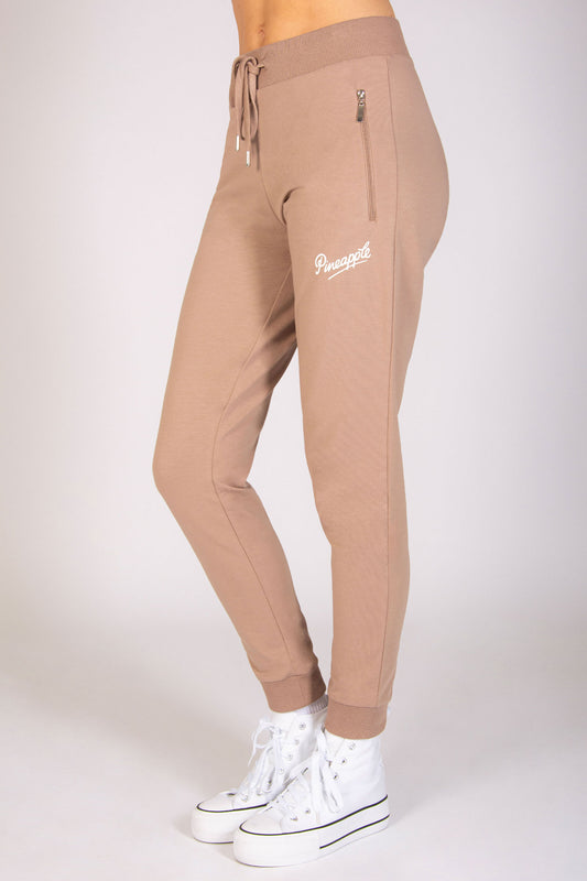 Women's light brown skinny zip joggers with drawcord waistband and cuffs