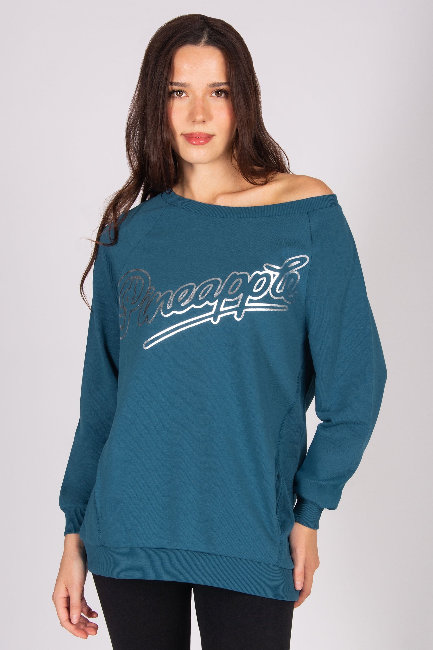 Woman wearing a dark blue sweatshirt off the shoulder