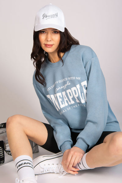 Light blue unisex sweatshirt with logo chest print, oversized baggy fit and cuffed hem.