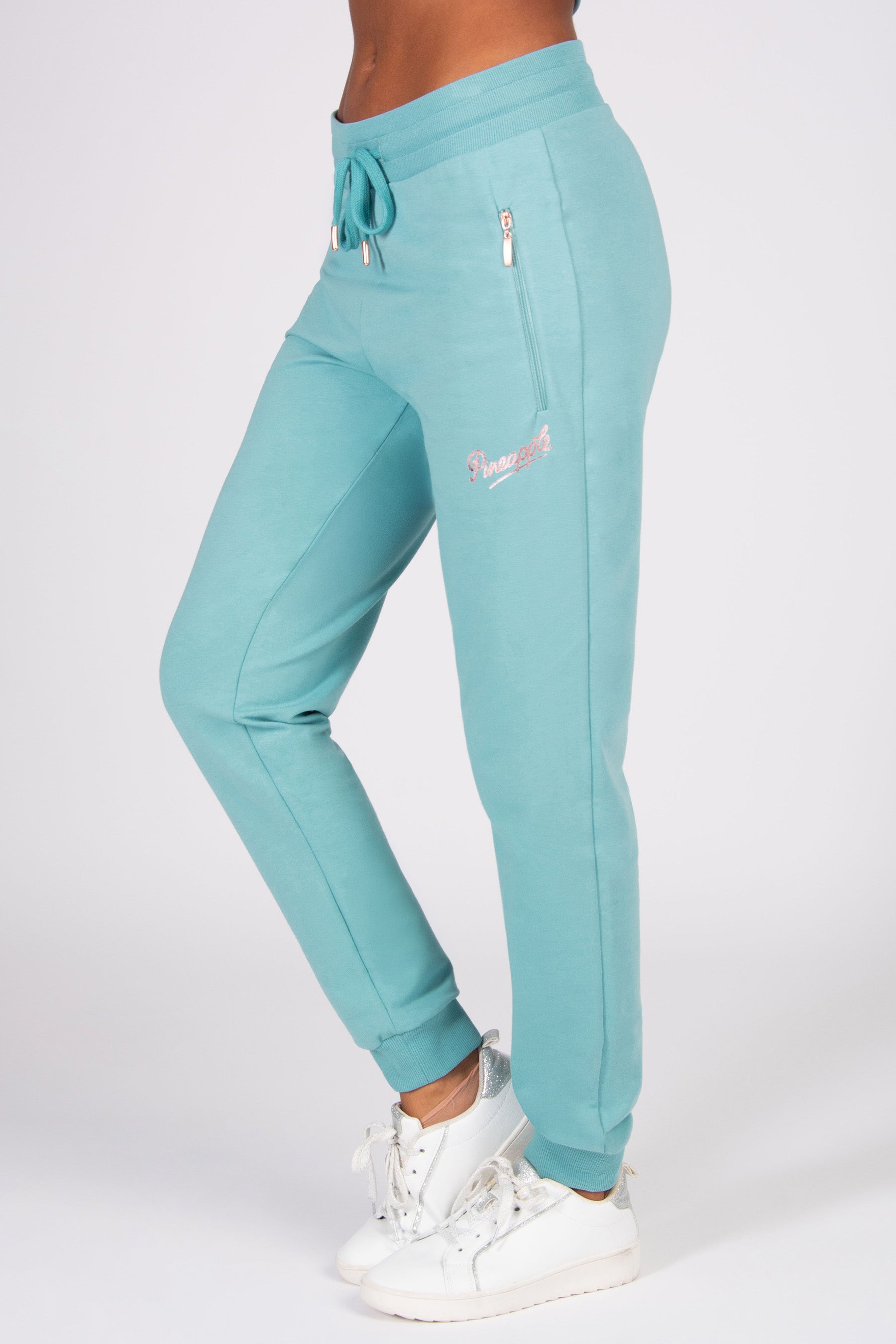 Teal jogger pants with a brand logo on a white background
