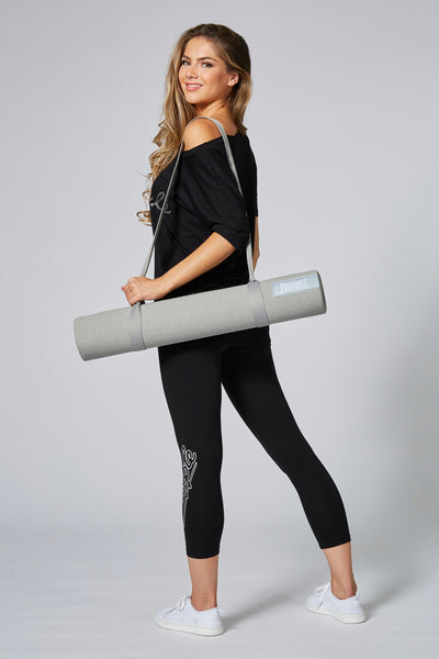 Woman carrying Pineapple Dance Grey Badge Yoga Mat