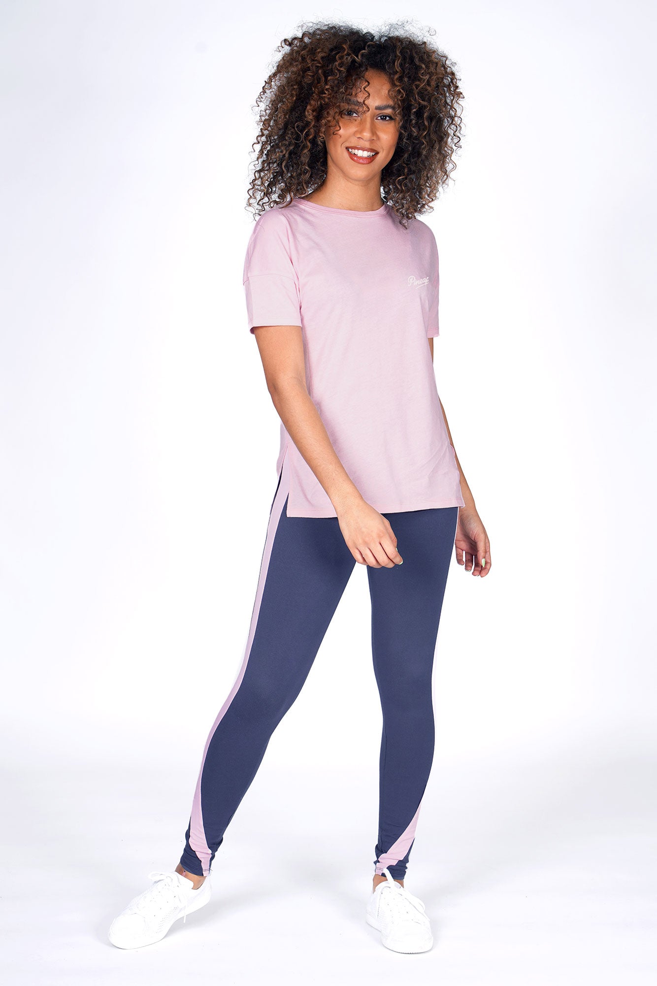 Woman wearing Charcoal Racer Stripe Leggings and Coral Side Slit T-Shirt