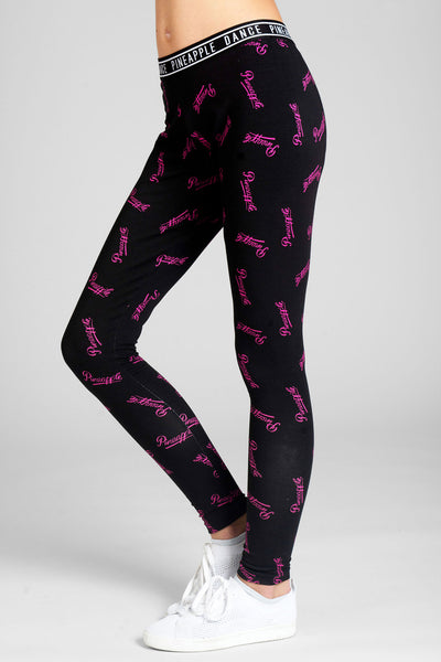 Girl wearing Pineapple Leggings with pink all-over logo print