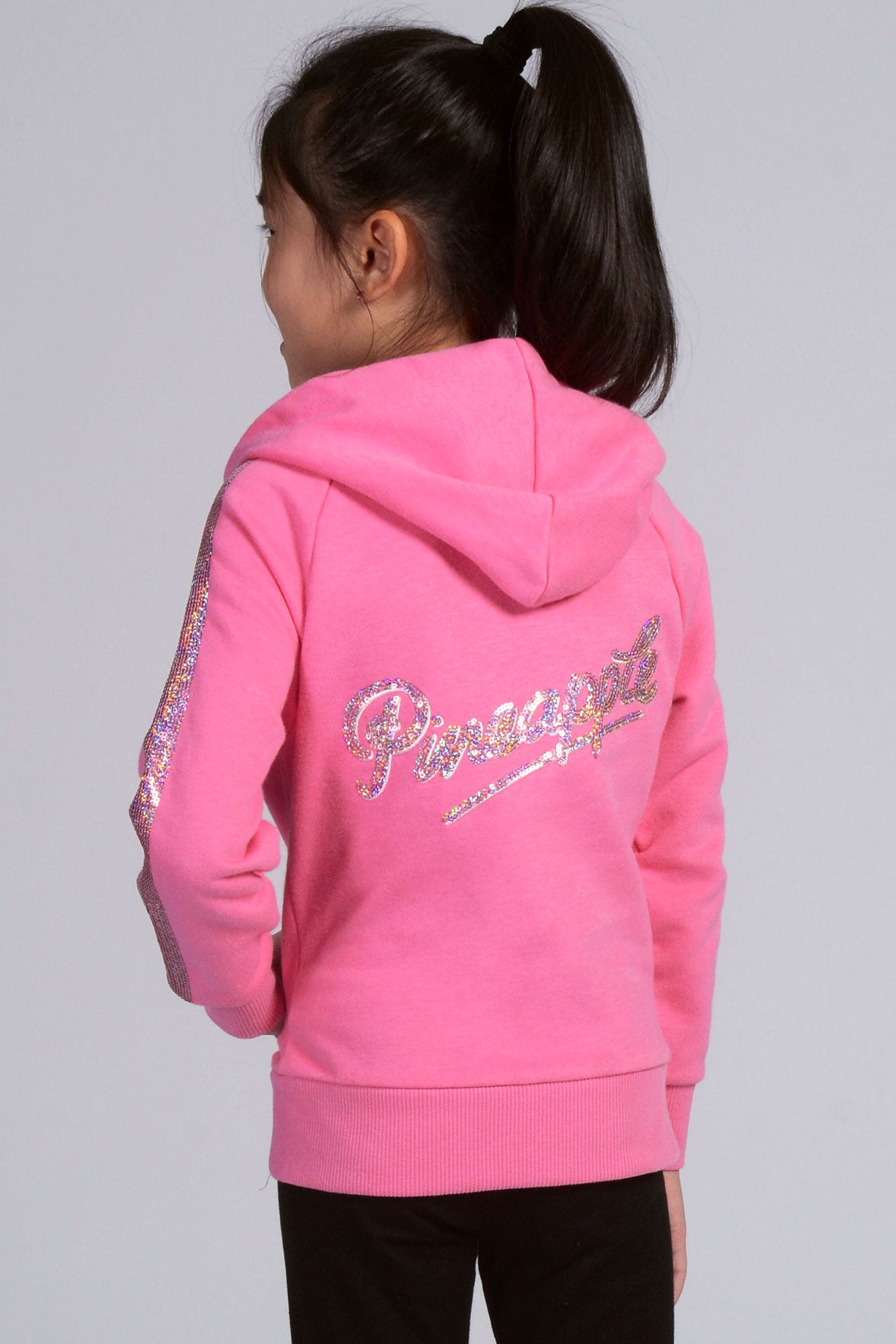 Girl wearing pink Zip Hoodie with Sequin logo on the back