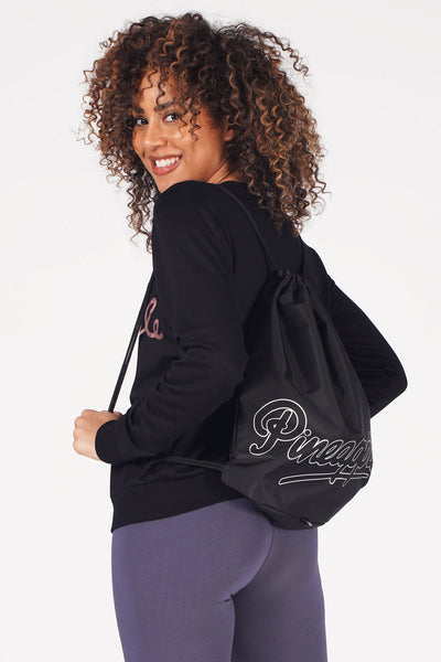 Woman carrying Pineapple Black Drawstring Bag